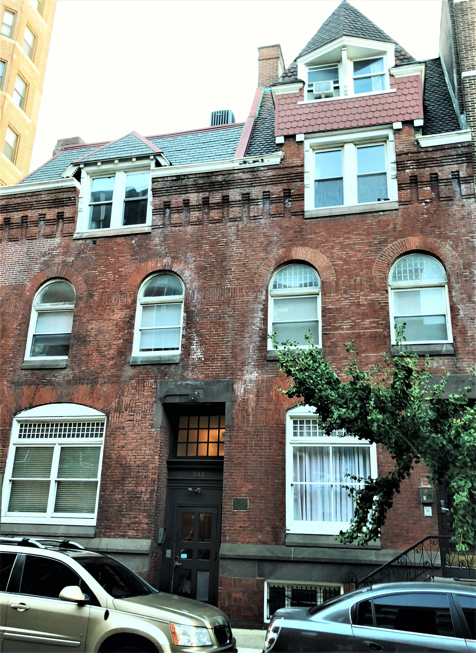 242 South 13th Street, a multi-story brick building with arched windows.