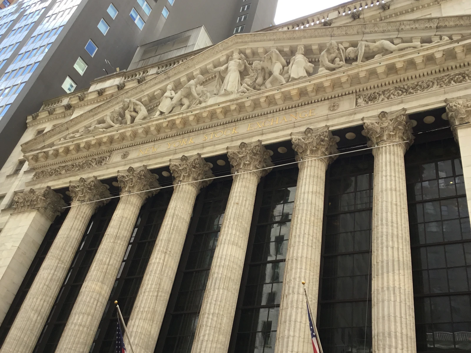 Exterior facade of the New York Stock Exchange building with columns and sculptures.
