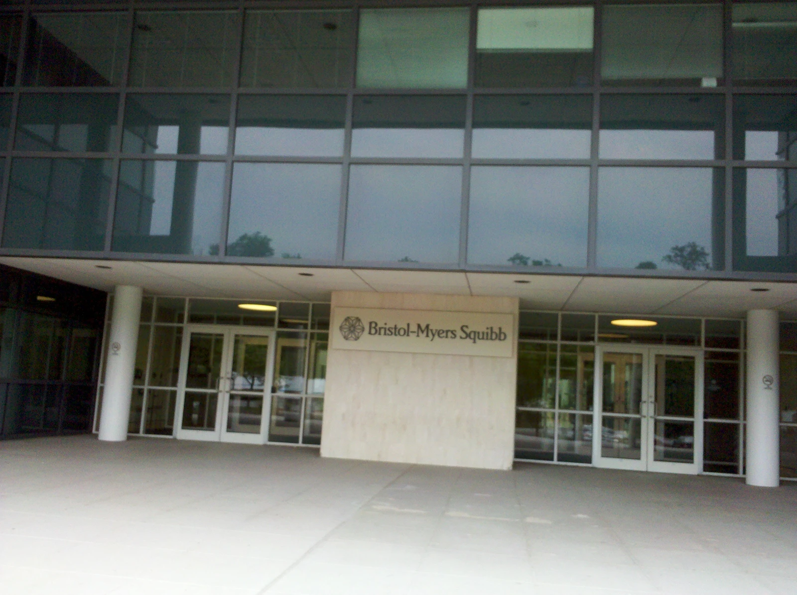 Exterior view of the Bristol-Myers Squibb building entrance with company signage.
