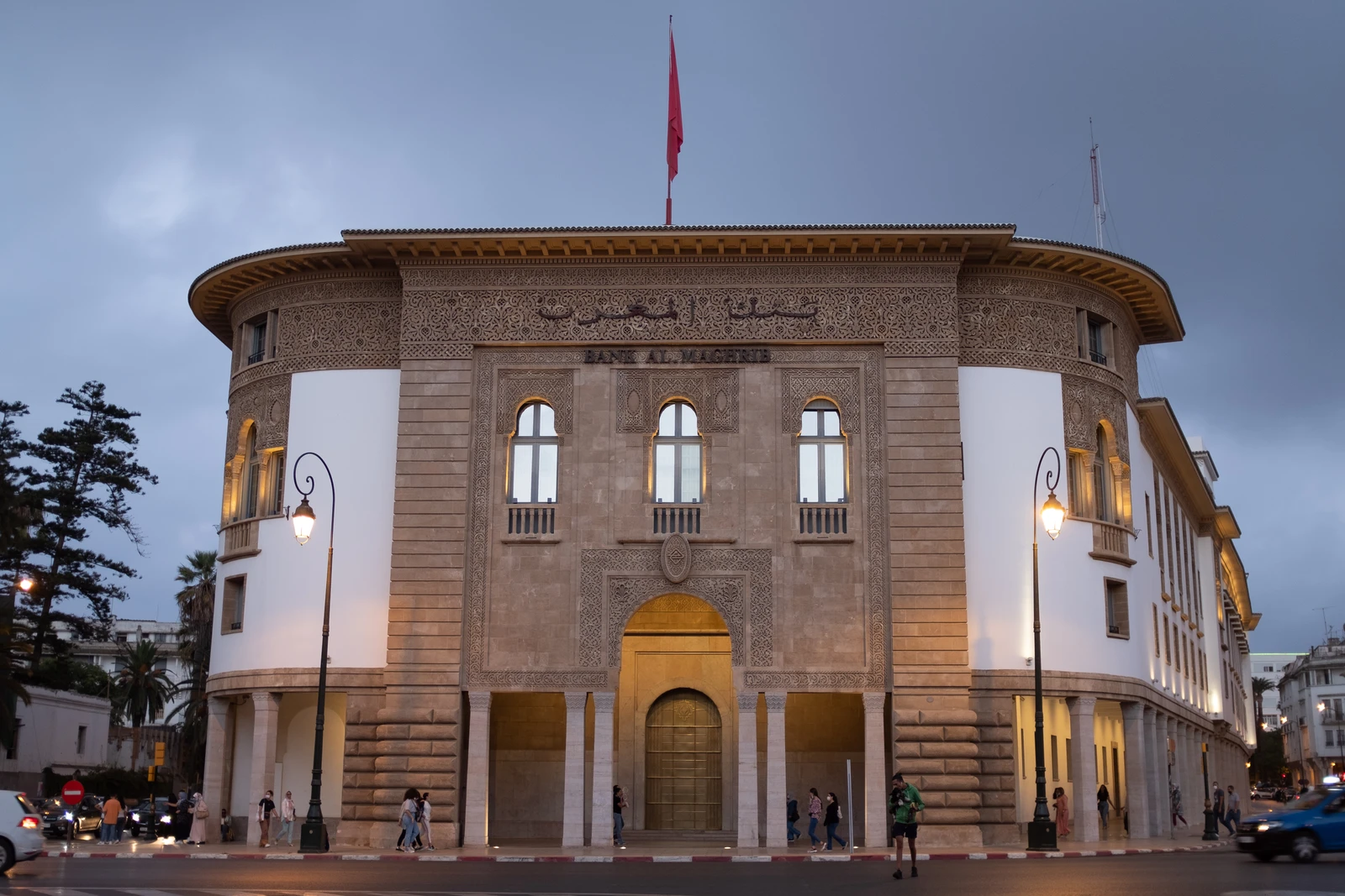 Exterior view of the Bank Al-Maghrib building in Rabat, Morocco, with a red flag.