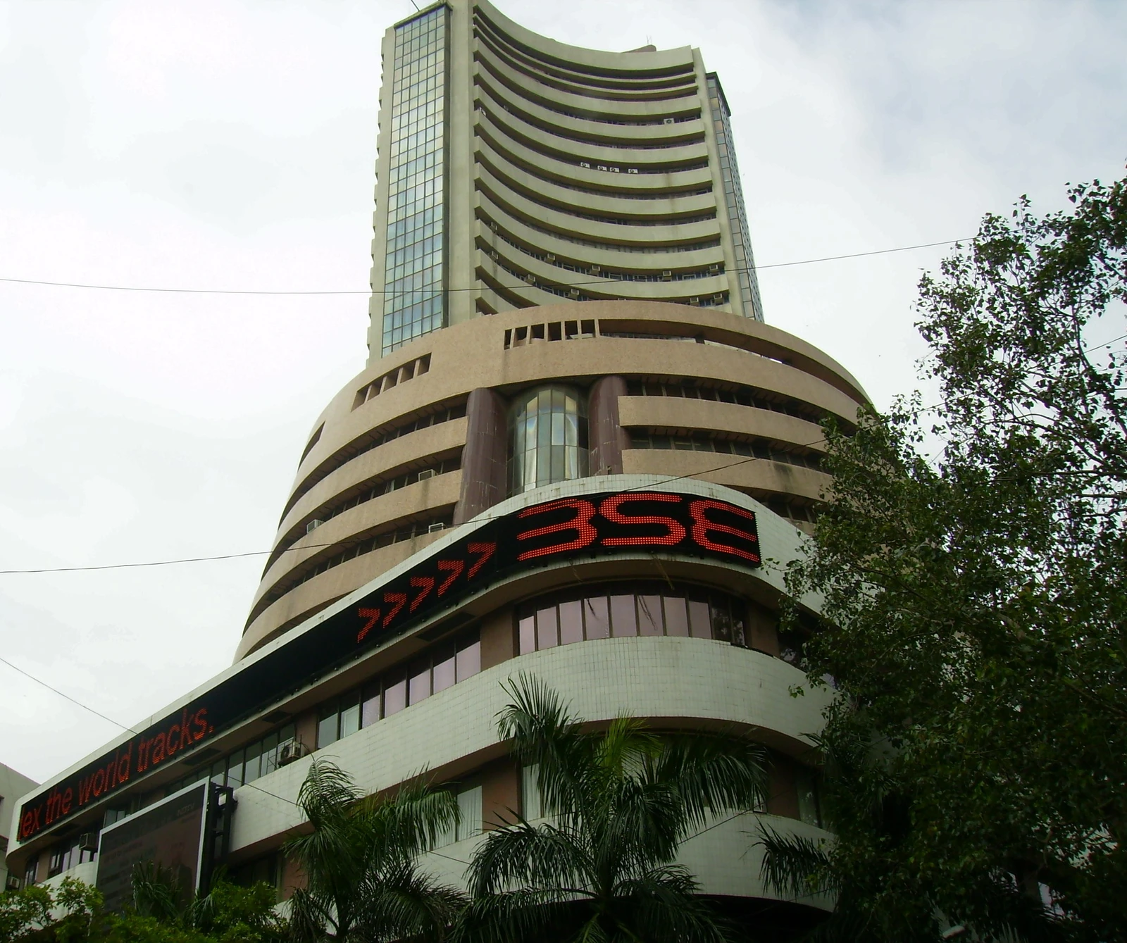 The Bombay Stock Exchange building, a multi-story structure with curved facades and a digital display.