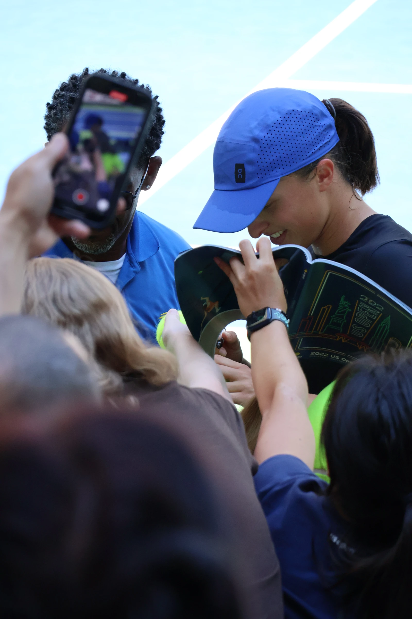 Iga Świątek, tennis player, signing autographs for fans.
