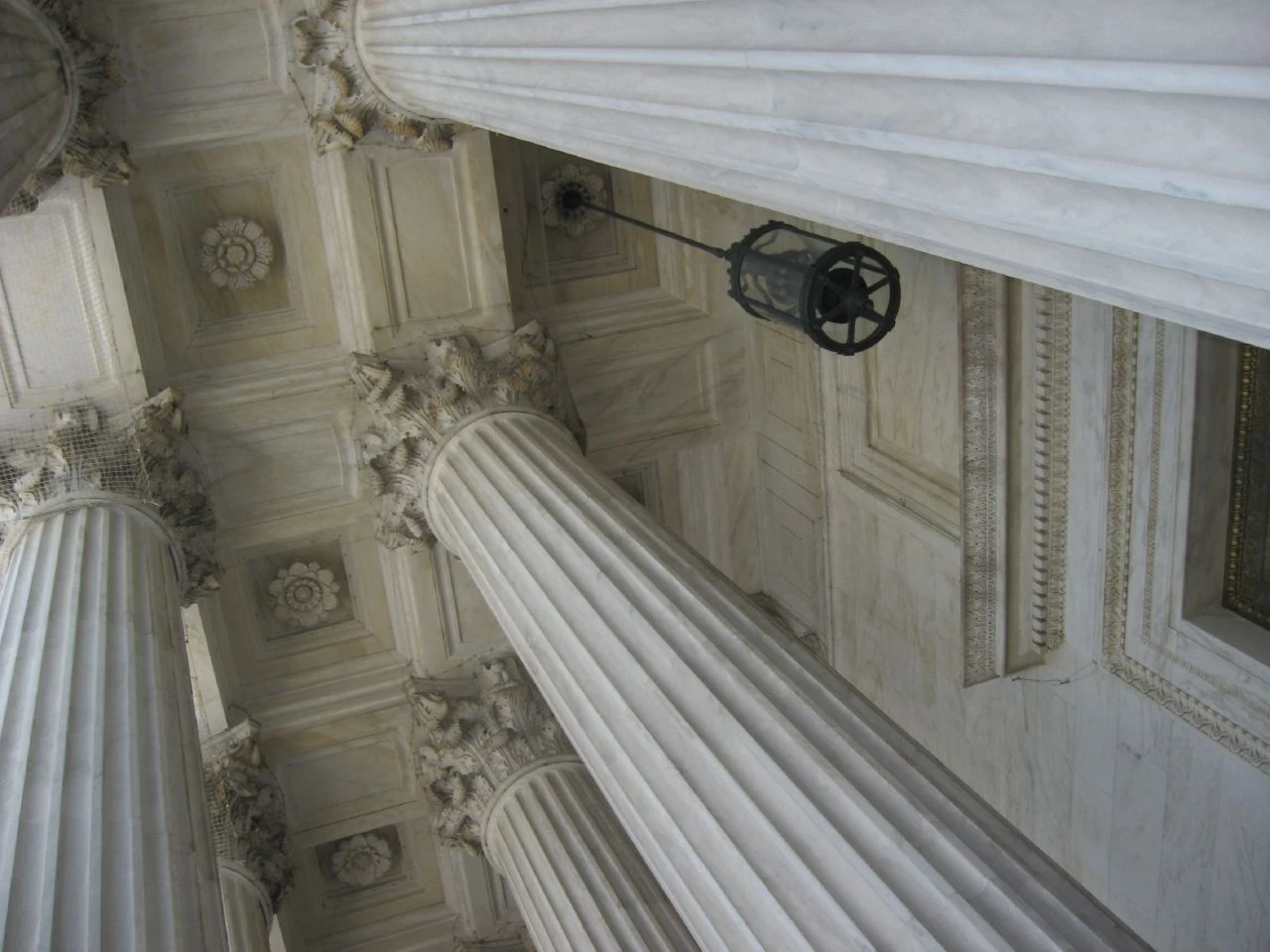 Entrance of the Supreme Court Building in Washington, D.C., with large classical columns.