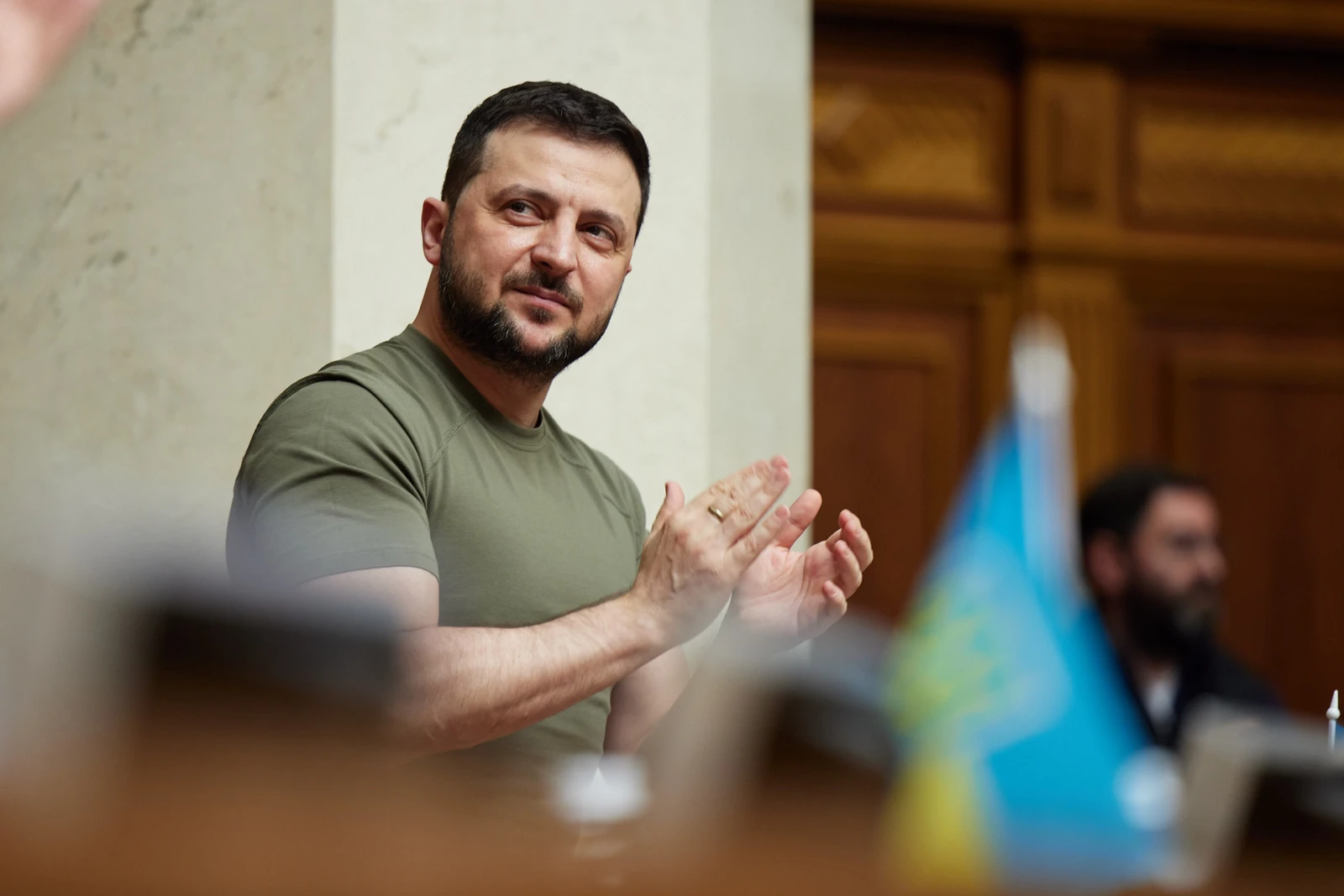 Ukrainian President Volodymyr Zelenskyy clapping inside the Verkhovna Rada.