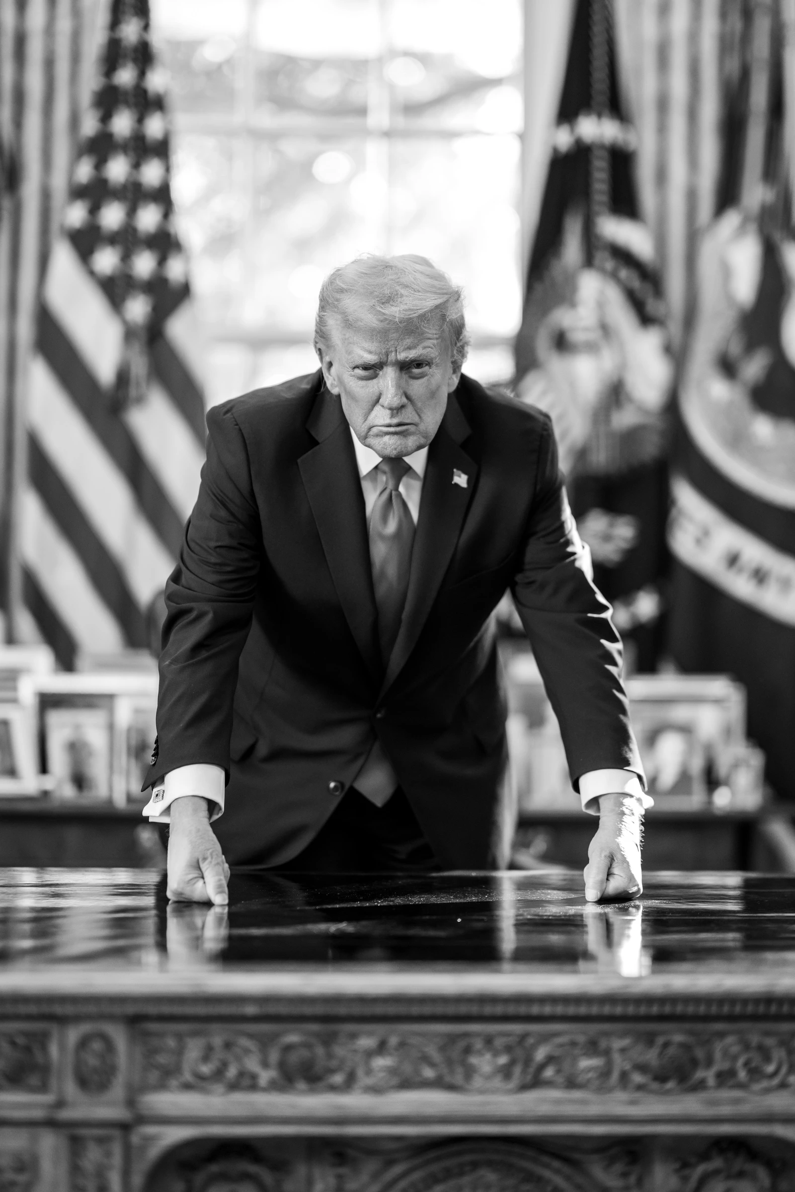Donald Trump, former President of the United States, stands at a desk in the Oval Office.