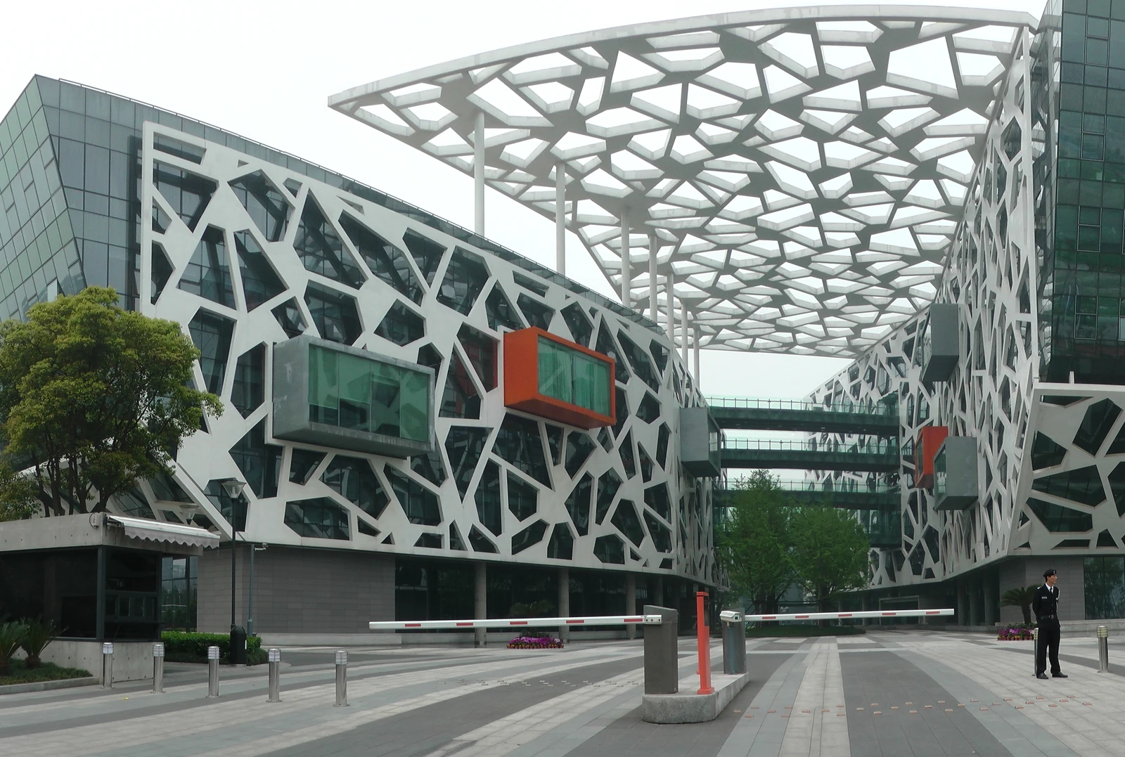 Exterior view of Alibaba Group Headquarters complex with modern architecture and security gate.