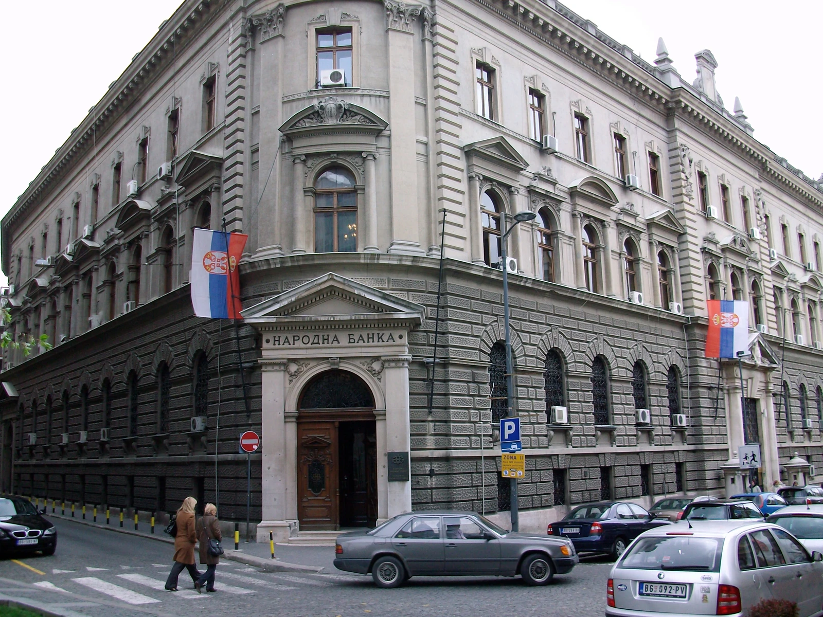 Exterior view of the National Bank of Serbia building with a Serbian flag.