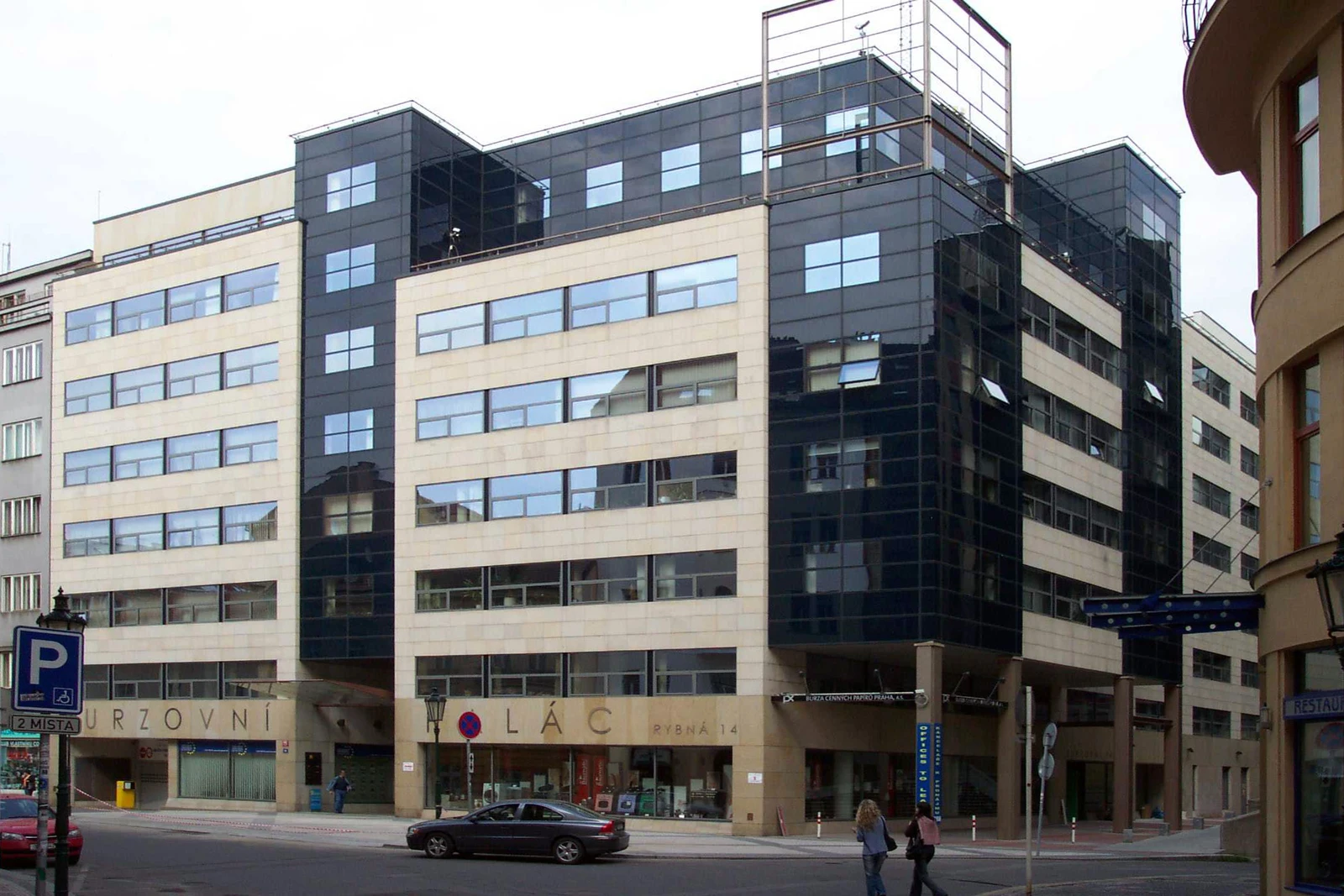 Modern office building with beige and dark glass facade in Prague, Czech Republic.