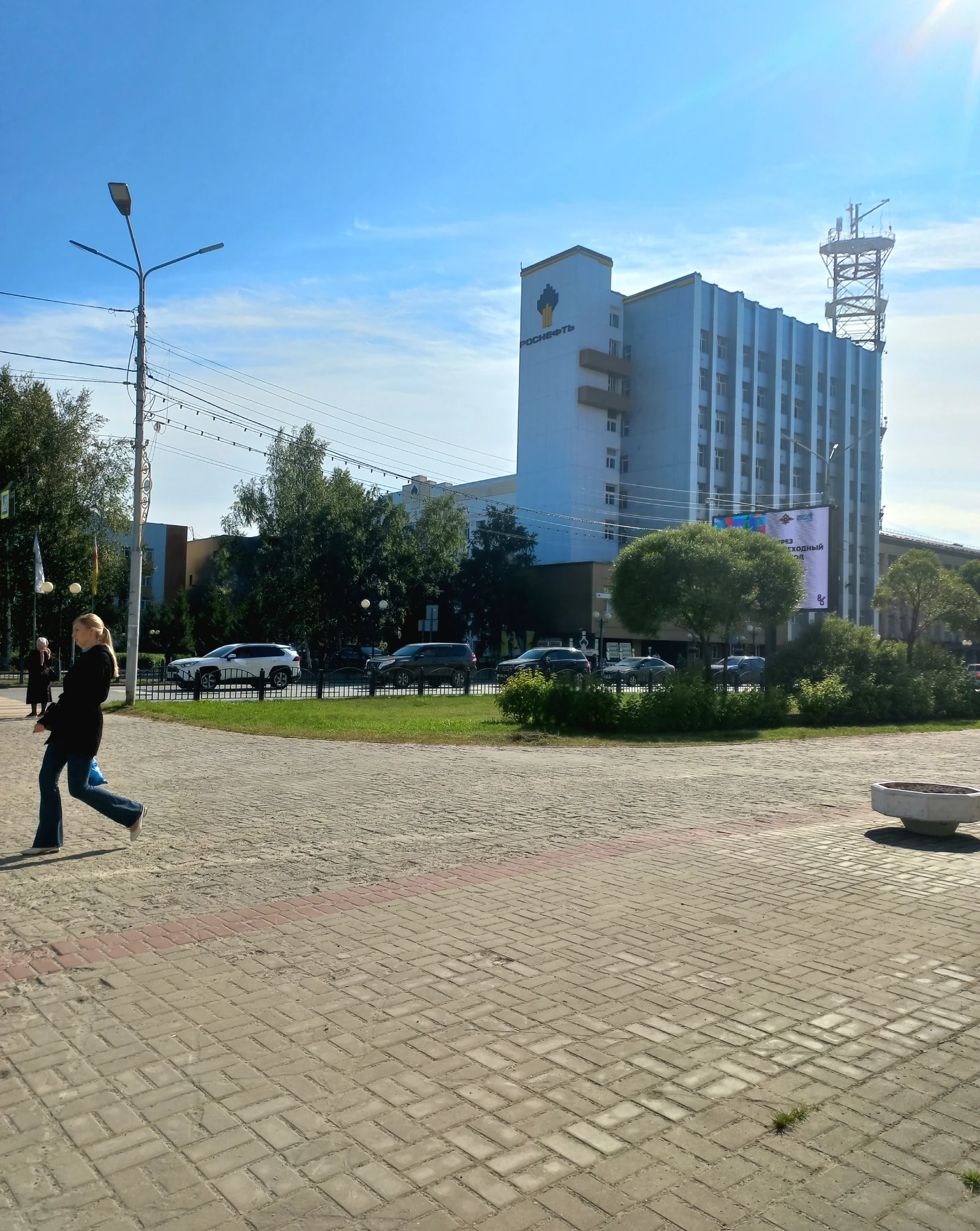 Exterior view of the Rosneft (RN-Yuganskneftegaz) office building, with a street in front.