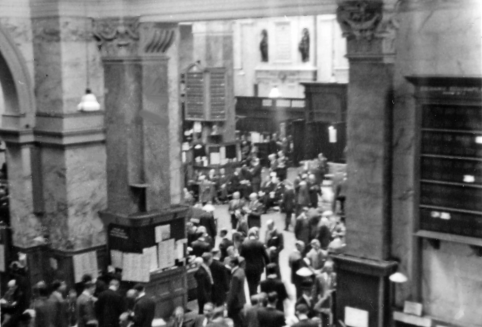 People on the trading floor of the London Stock Exchange in a black and white photograph.