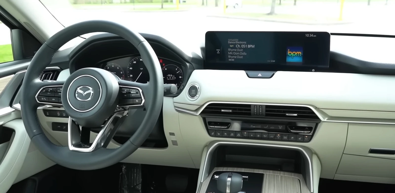 Interior of a Mazda CX-90 showing the steering wheel and dashboard.