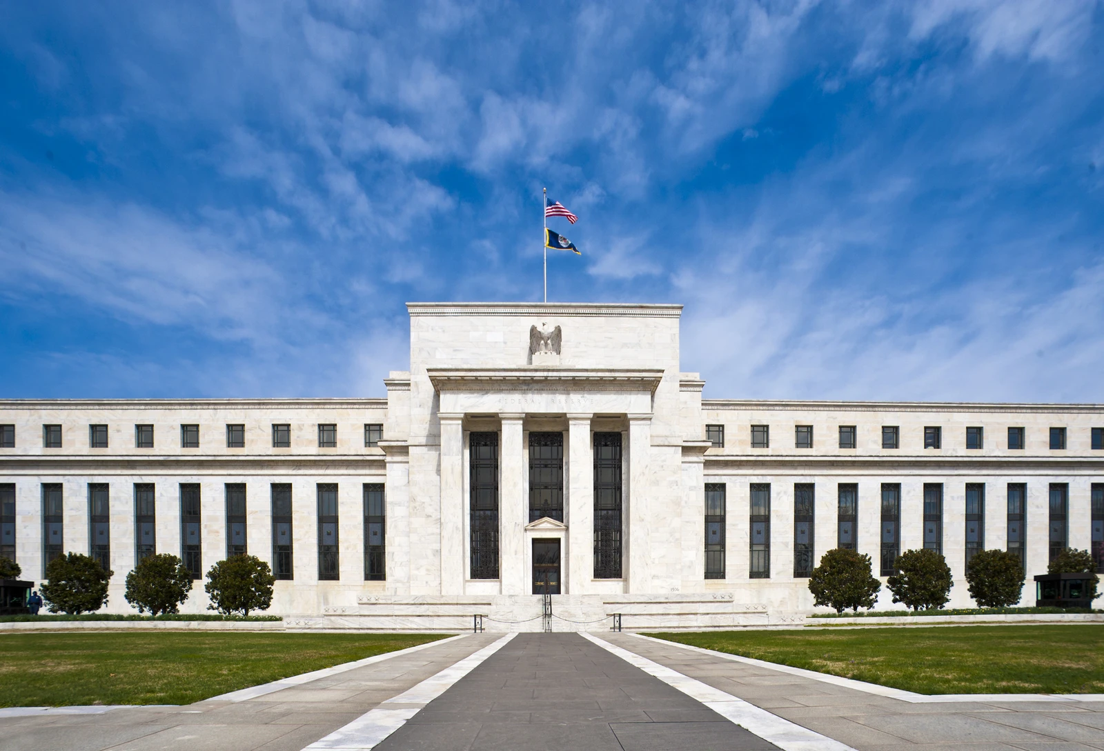 Marriner S. Eccles Federal Reserve Board Building exterior with American flags flying.