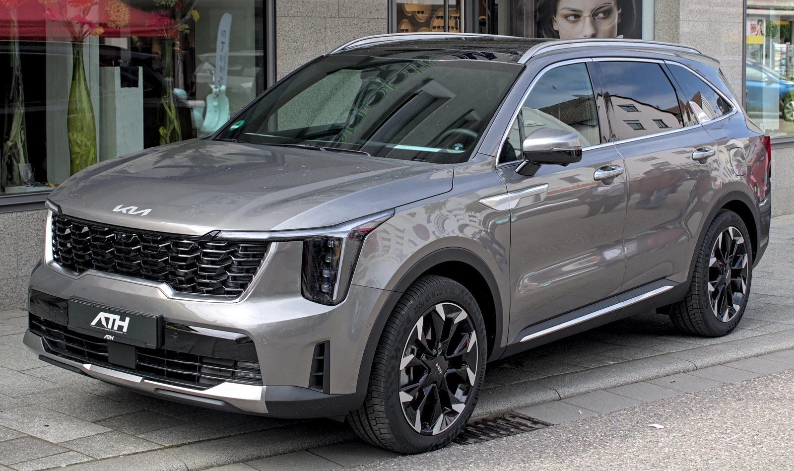 A gray 2024 Kia Sorento (MQ4) parked on a city street.