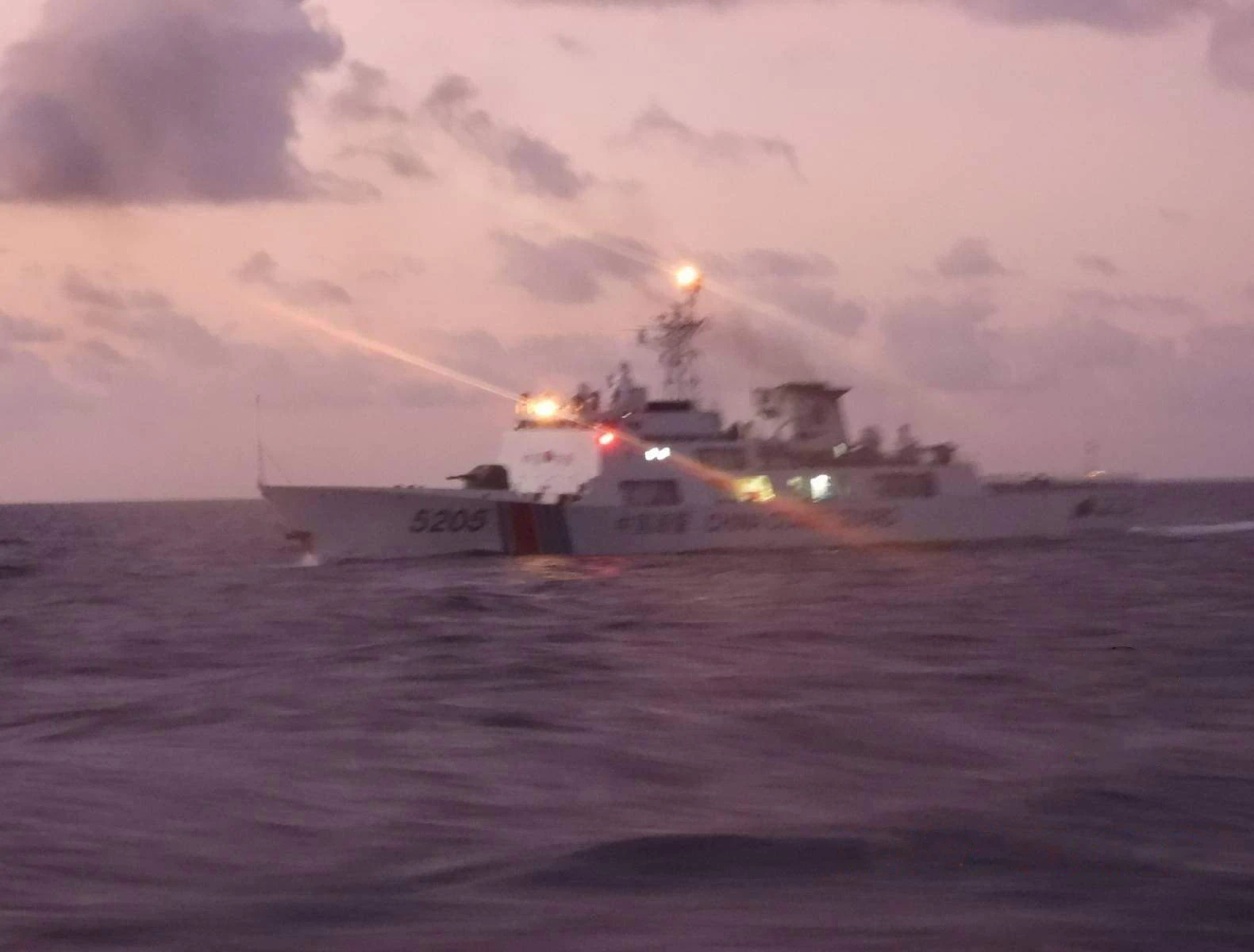 Chinese Coast Guard vessel 5205 with bright lights on water during a laser incident.